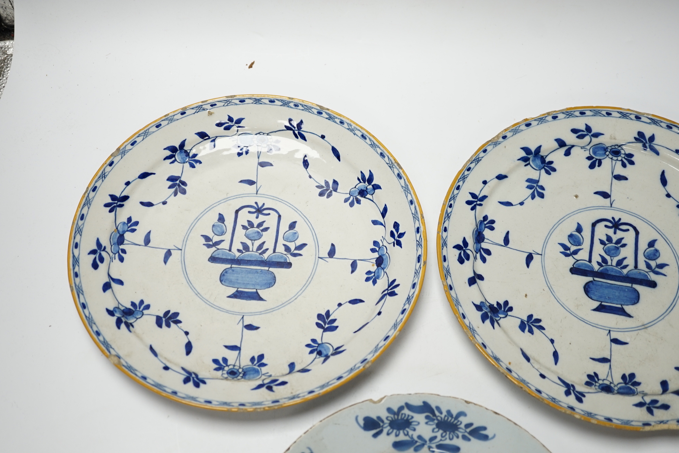 A pair of late 18th century Delft plates and an English delftware plate (3)